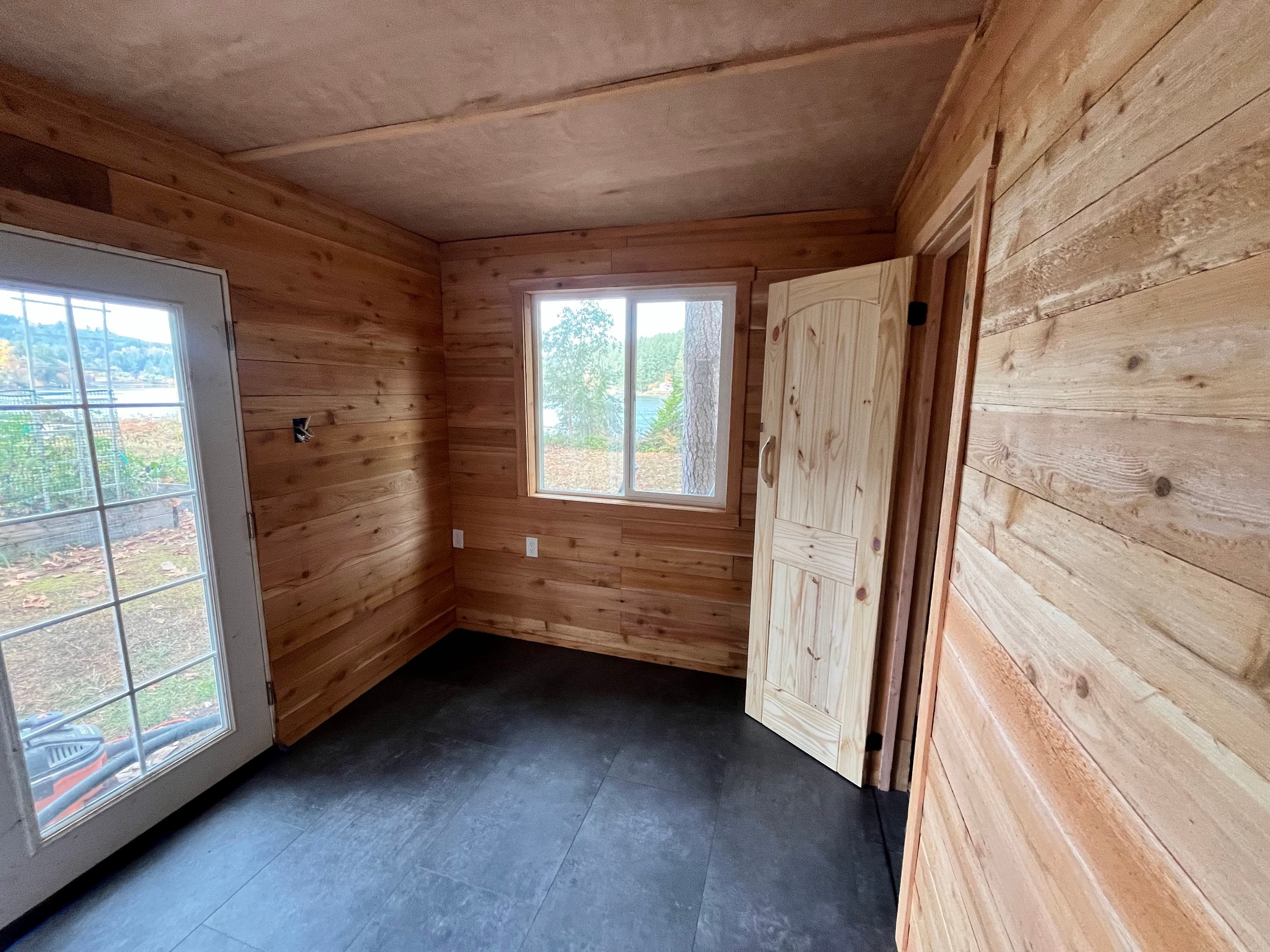 Sauna warm room with view windows toward Puget Sound