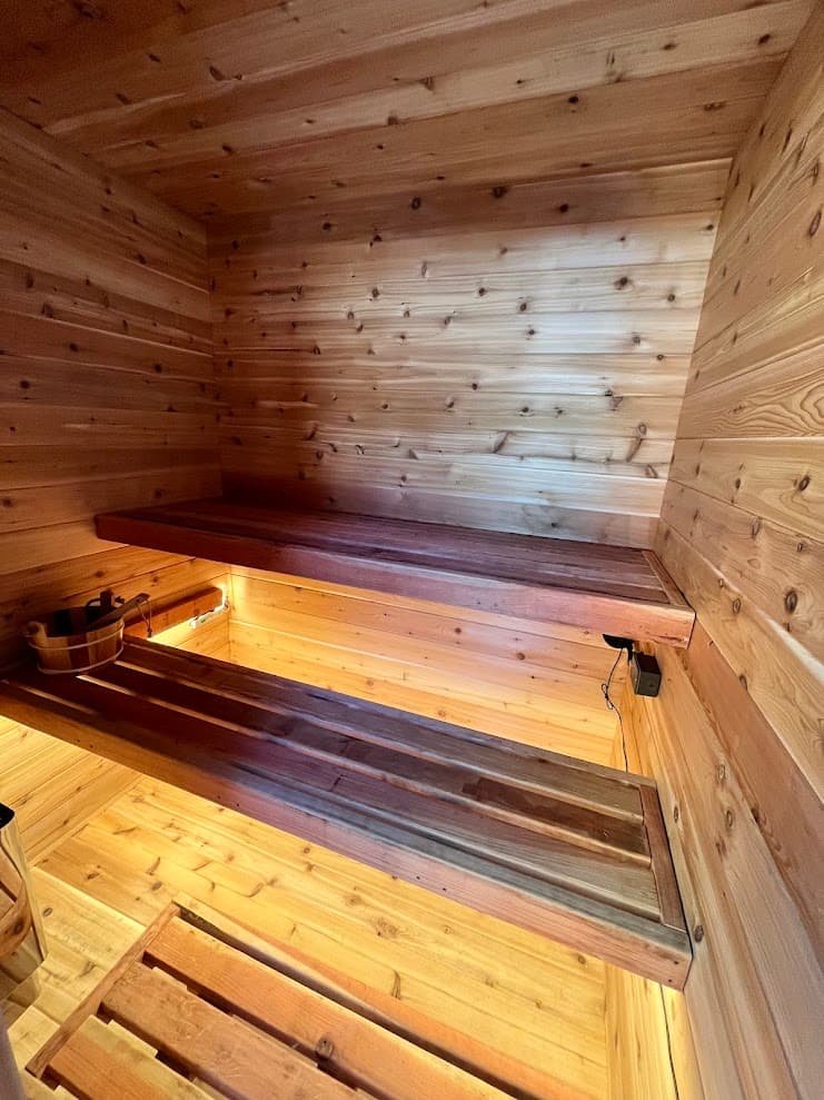 Three-tier parallel redwood benches with cedar walls and under-bench LED lighting