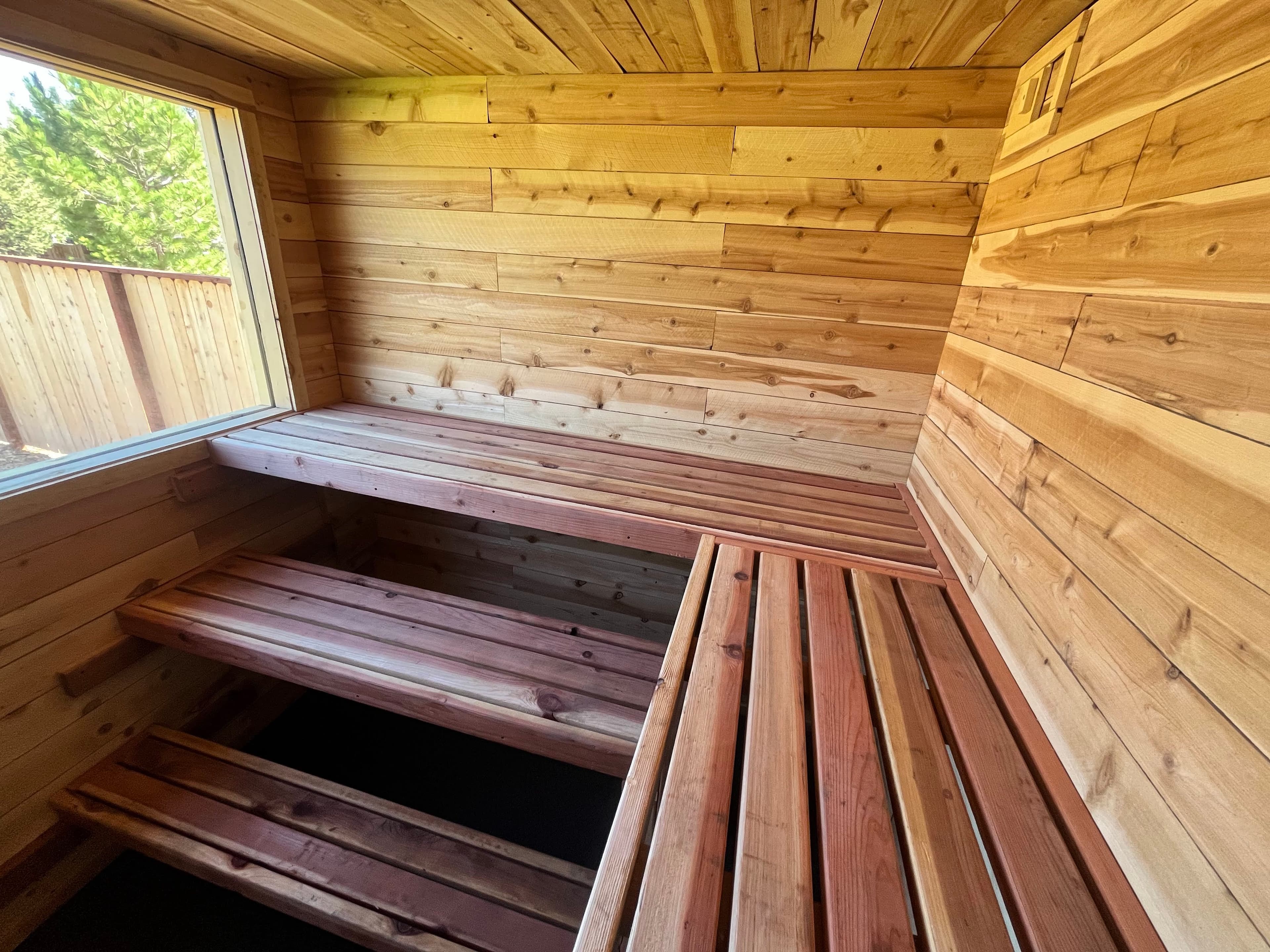 Completed 8x8 outdoor sauna with gable roof and cedar siding next to house – South Lake Tahoe