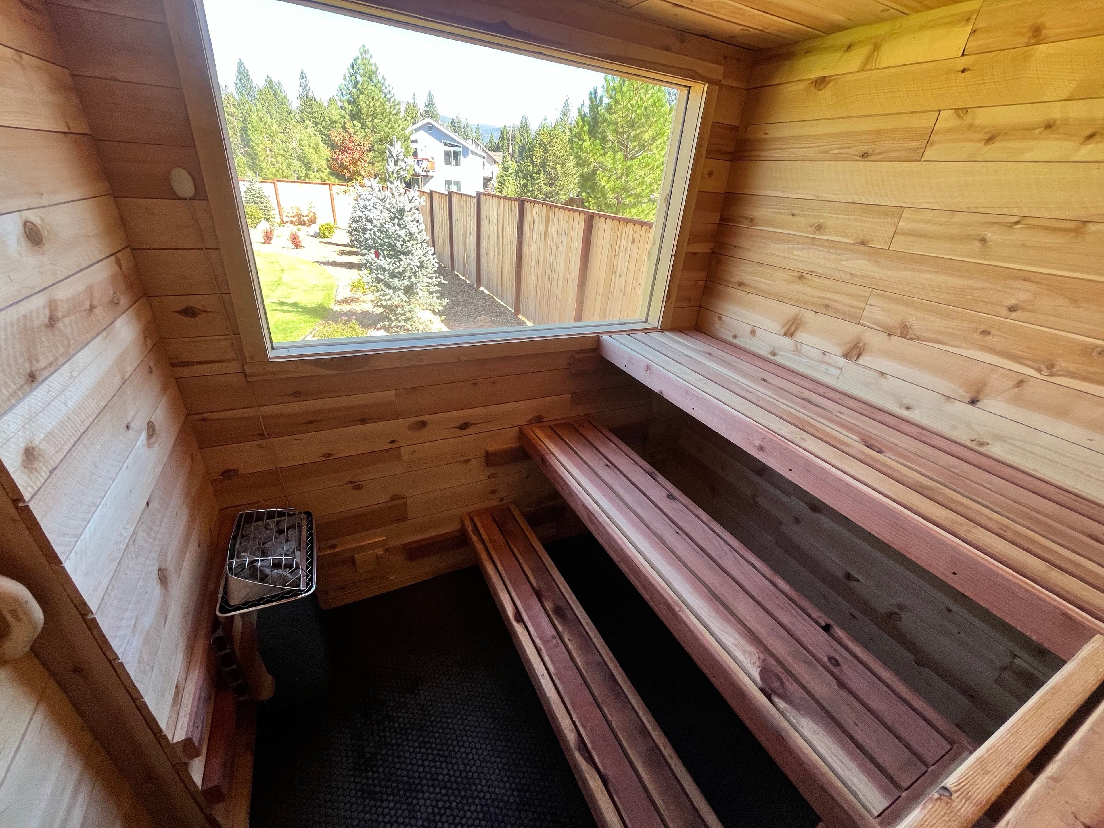 Cedar interior with three-tier L-bench and large picture window overlooking mountain – South Lake Tahoe