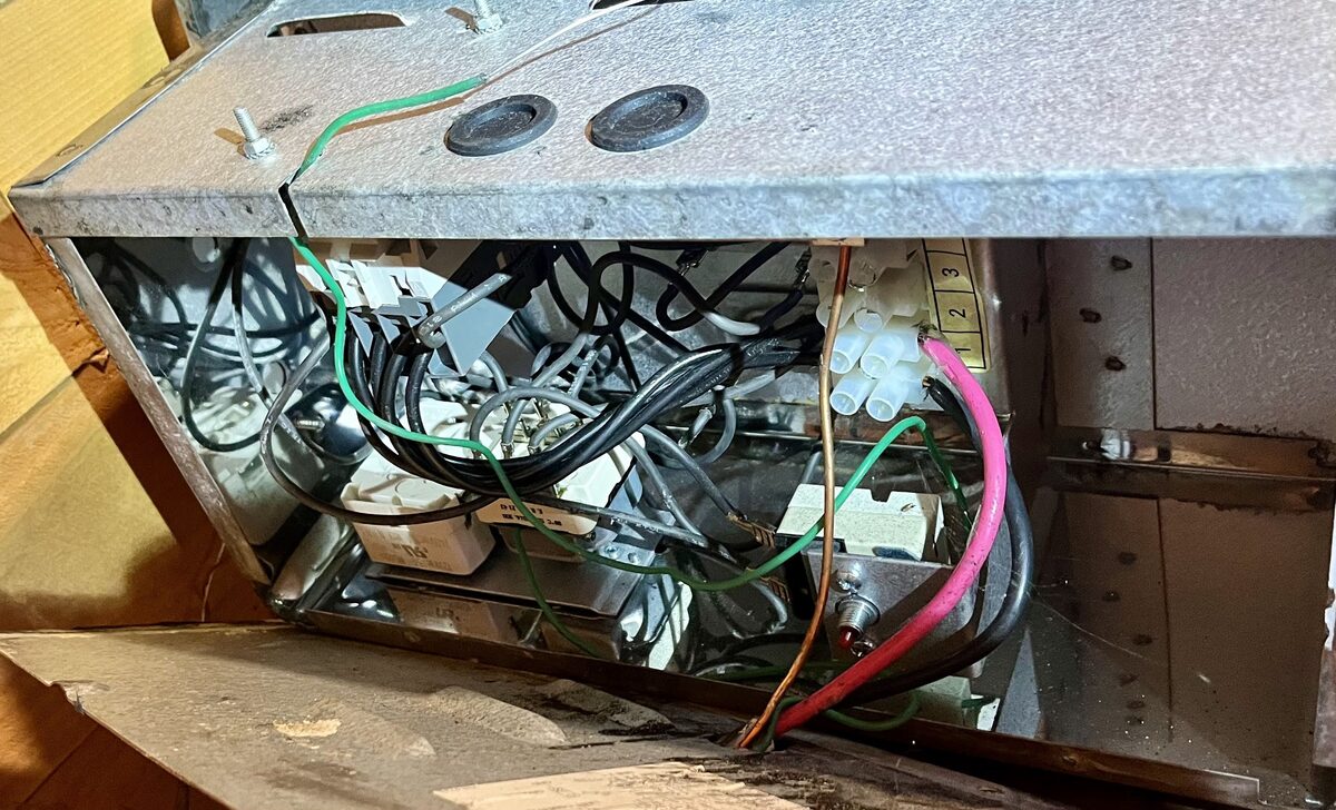 The heater bottom cover removed, exposing the element mounts and wiring