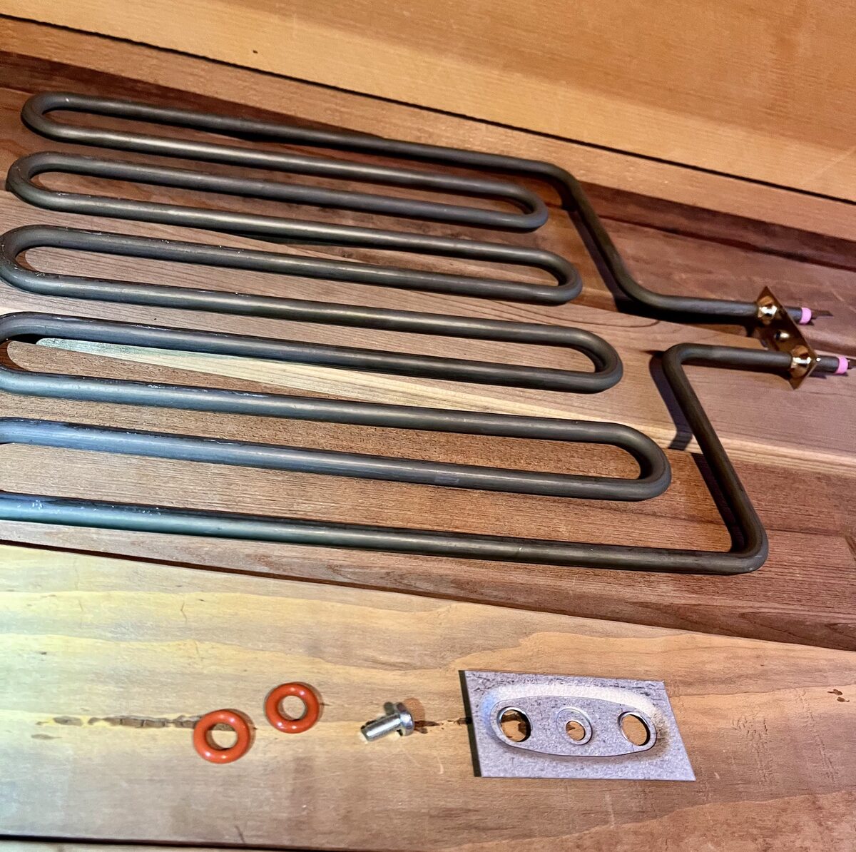 The replacement element with its mounting bracket and seal grommets