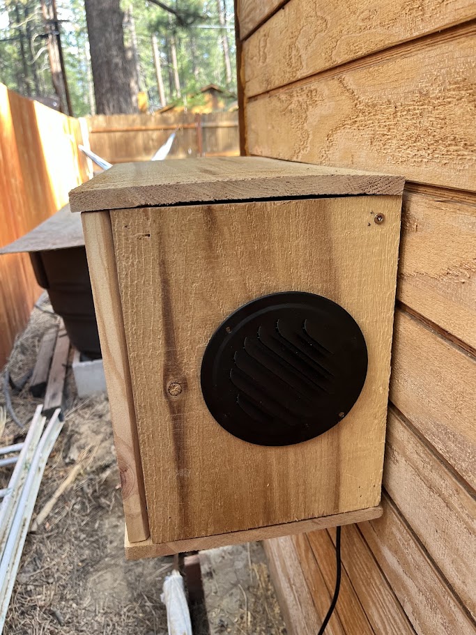 Front view of the finished wood cover with the louvered vent grill