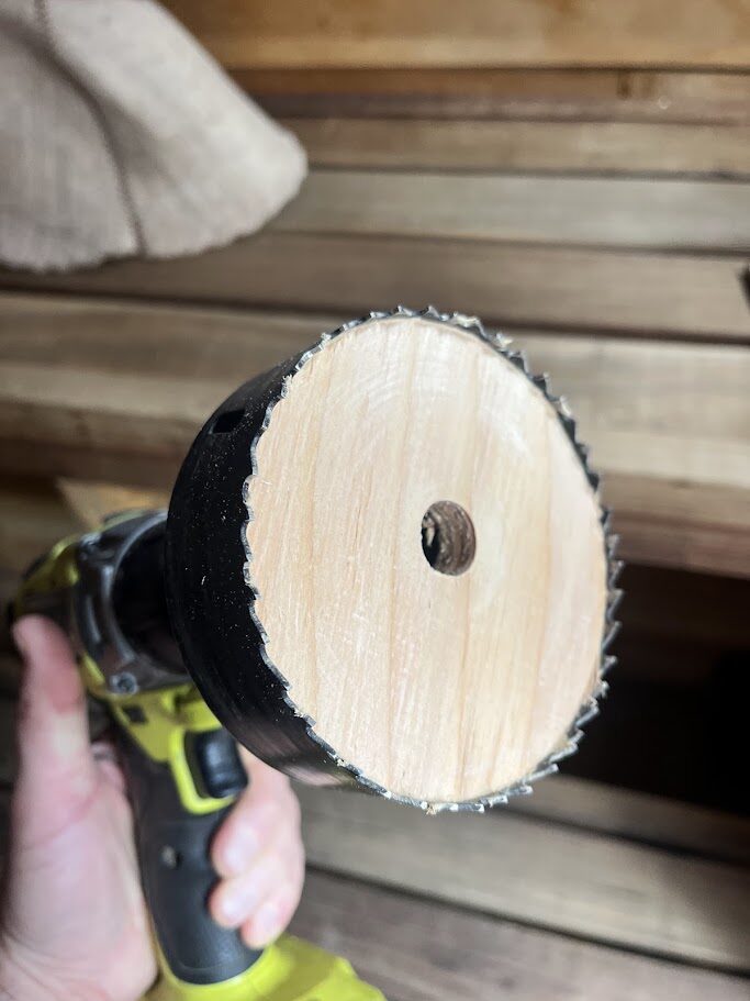 The wood core pulled out of the hole saw after cutting the vent opening